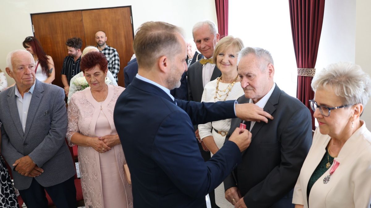 Burmistrz Polic Krystian Kowalewski wręcza medale jubilatom